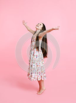 Portrait of adorable smiling little girl child dancing in dress 