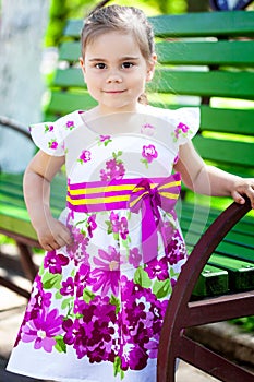 Portrait of adorable smiling little girl child in dress outdoor