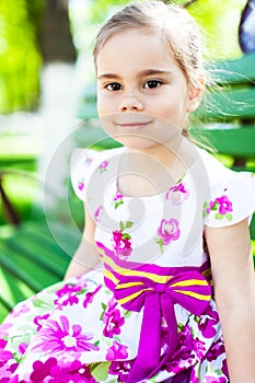 Portrait of adorable smiling little girl child in dress outdoor