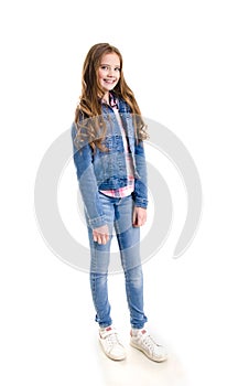 Portrait of adorable smiling little girl child preteen standing isolated