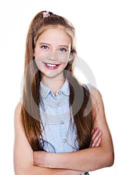Portrait of adorable smiling little girl child schoolgirl teenager in dress with long hair standing isolated