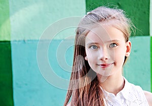 Portrait of adorable smiling little girl child schoolgirl teenager outdoors