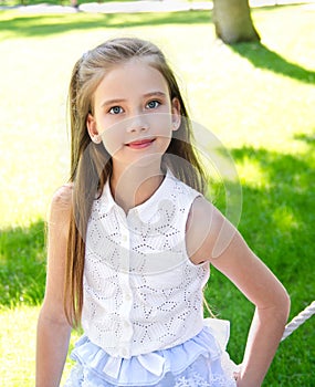 Portrait of adorable smiling little girl child schoolgirl teenager outdoors