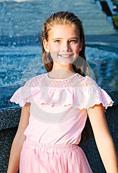 Portrait of adorable smiling little girl child on summer day