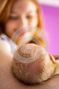 Portrait adorable smiling redhead mother posing with newborn baby feeling love enjoying motherhood