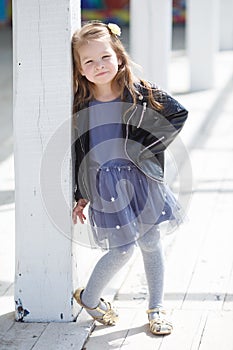 Portrait of an adorable toddler girl wearing fashion clothes.