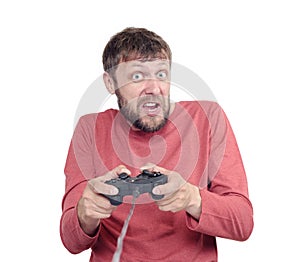 Portrait of adult bearded man holding joystick and playing videogames, isolated on white background