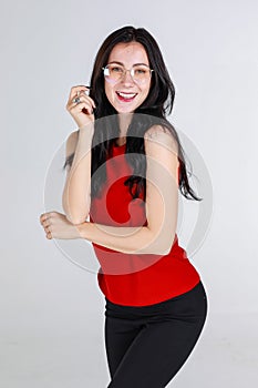 Portrait adult caucasian woman about 25-30 years old wearing red sleeveless dress standing and smiling and looking at camera feel