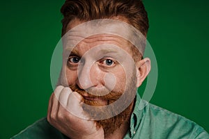 Portrait of adult handsome stylish bearded bored man propping head
