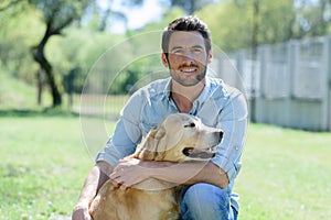 portrait adult man with golden retriever dog photo