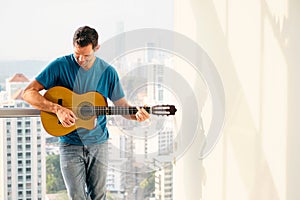 Portrait Of Adult Man Playing Classic Guitar And Singing