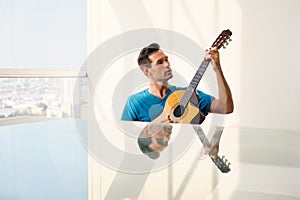 Portrait Of Adult Man Playing Classic Guitar And Singing