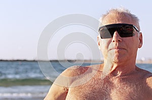 Portrait of an adult man sunbathing on the sea