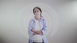 Portrait of adult proud Caucasian woman looking away with sarcastic smile. Ironical lady standing on white background