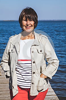 Portrait of adult woman on river bank