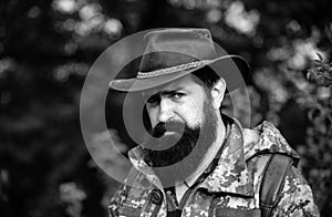 Portrait of adventure serious man extreme explorer. Man hunter in camouflage outdoor. Brutal hunter, bearded man in the