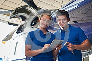 Portrait Of Aero Engineer And Apprentice Working On Helicopter I