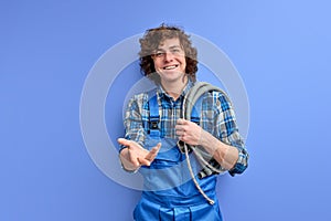 portrait of affable plumber man with hose on shoulders ready to help clients