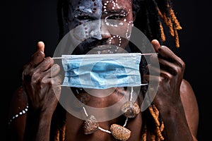 portrait of african aborigen male wearing medical mask on face
