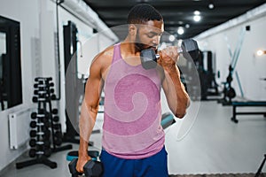 Portrait african american bodybuilder at gym intense intimidating glare expression conviction.