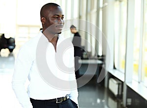 Portrait of African American business man with executives working in background