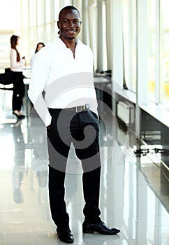 Portrait of African American business man with executives working in background