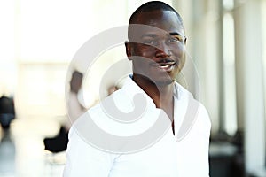 Portrait of African American business man with executives working in background