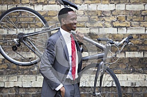 Portrait of African American businessman carrying Bicycle