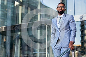 Portrait of an african american businessman in  a light suit, corporate executive, modern professional, successful entrepreneur CE