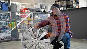 Portrait of african american buyer with a wheel disk