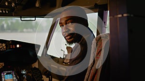 Portrait of african american copilot sitting in airplane cockpit