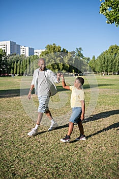 Portrait of African American dad and his son spending time