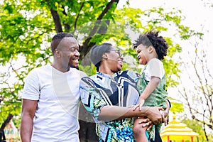 Portrait of African American family. Happy African American parent Father, mother and son are smiling together while standing in