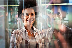 Portrait of african american female IT developer, programmer, designer working with programming code