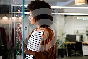 Portrait of african american female IT developer, programmer, designer working with programming code