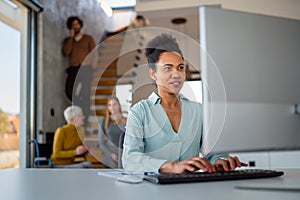 Portrait of african american female IT developer, programmer, designer working with programming code