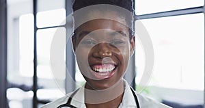 Portrait of african american female doctor looking at camera and smiling