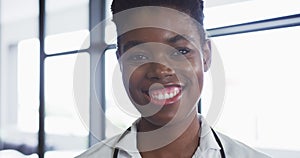 Portrait of african american female doctor looking at camera and smiling