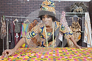 Portrait of an African American female fashion designer working on a pattern cloth