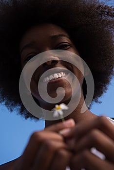 Portrait of African American girl with a flower in her hand