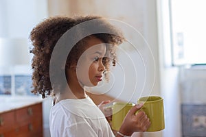 Portrait of African American girl with mugs