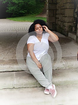 Portrait of a African American girl sitting on steps outide in Cleveland, Ohio