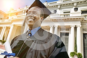Portrait of African American Graduate with Diploma in Front of University Building