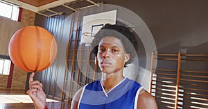 Portrait of african american male basketball player holding ball