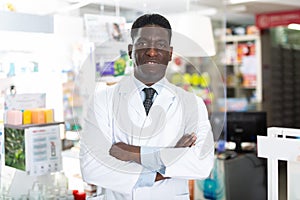 Portrait of an african american male pharmacist standing in the sales hall of a pharmacy