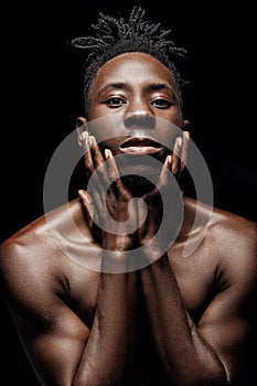 Portrait of African-American man on black background