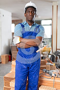 Portrait of african-american man repairer in building site