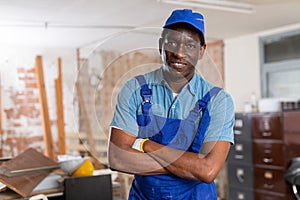 Portrait of african-american man repairer in building site