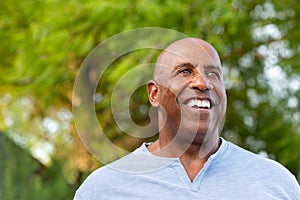 Portrait of an African American man standing in nature.