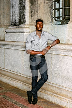 Young black man standing on street in New York City, thinking